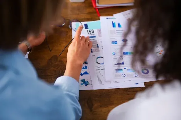 Two people looking at recruitment metrics